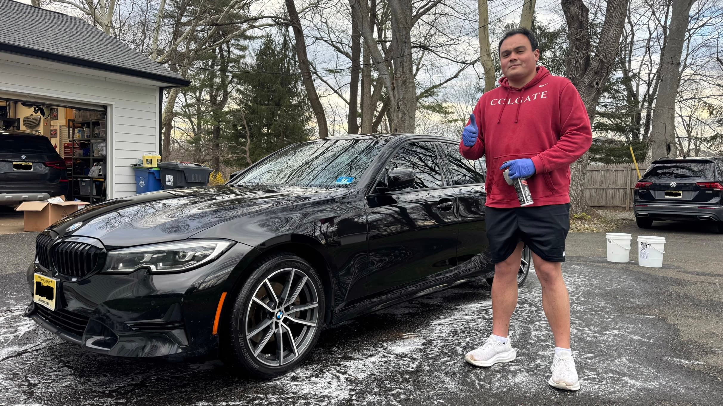 Jersey Auto Detailing hand-washing a car in a customer's driveway